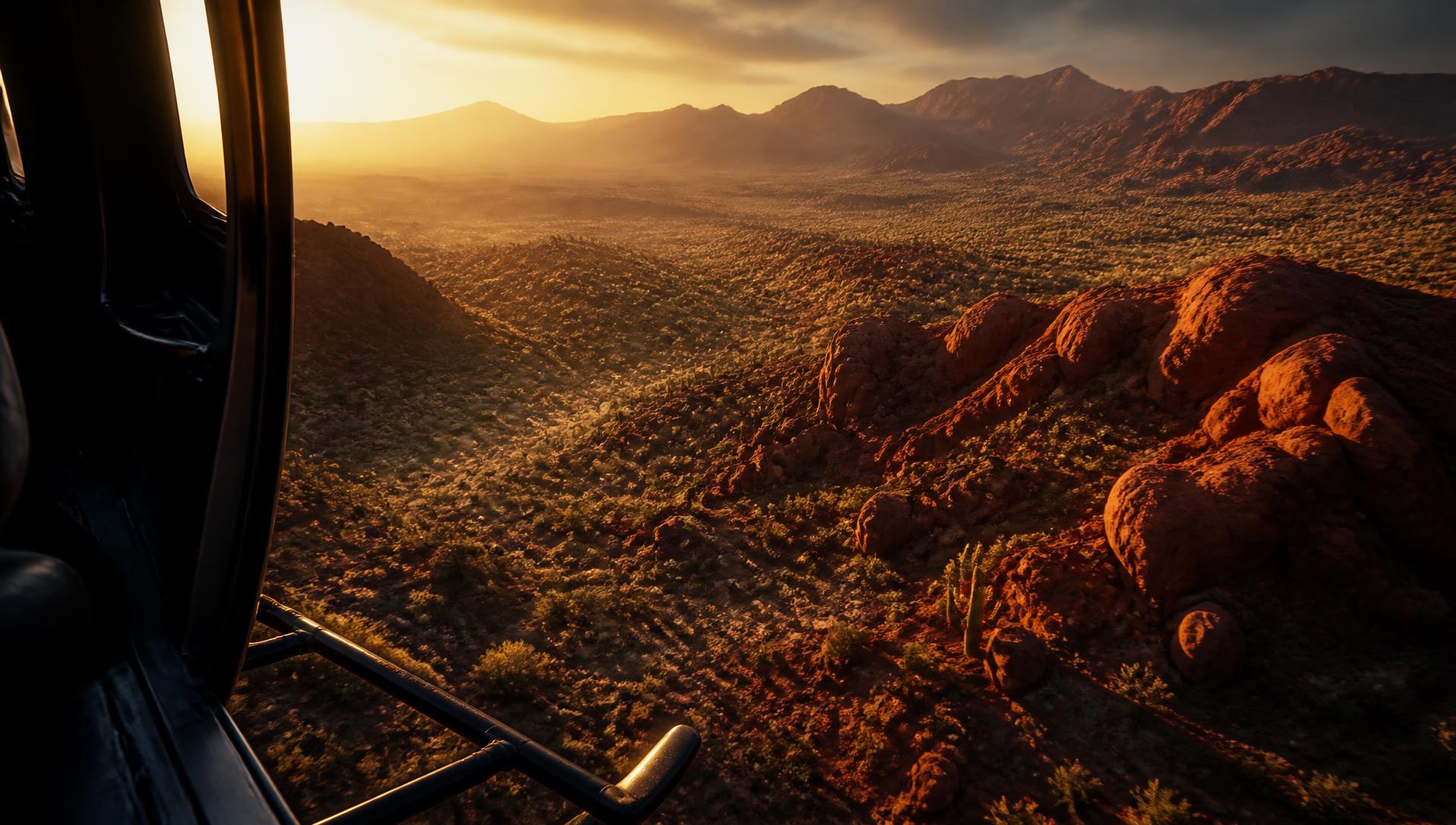 View of the Arizona desert at sunset from the open door of a helicopter